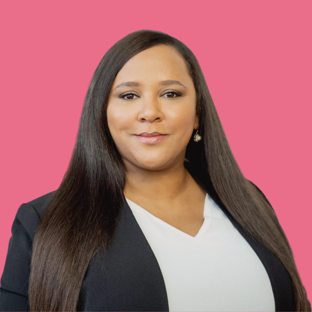 Meryl Afrika in black blazer and white blouse on pink background
