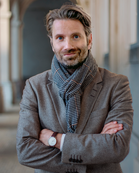 Meik Wiking wearing scarf and brown blazer