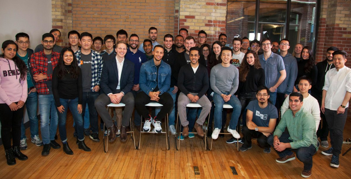 A group picture of the Snapcommerce team with Steph Curry.