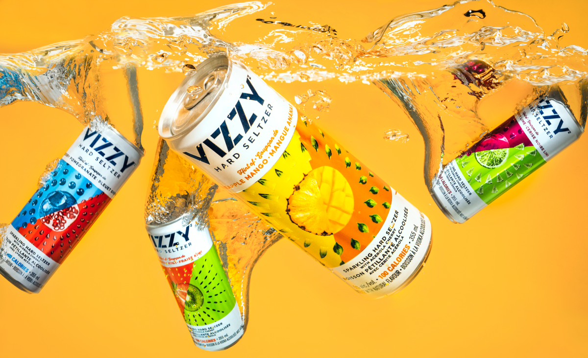 Vizzy Cans spraying water to show how refreshing they are.