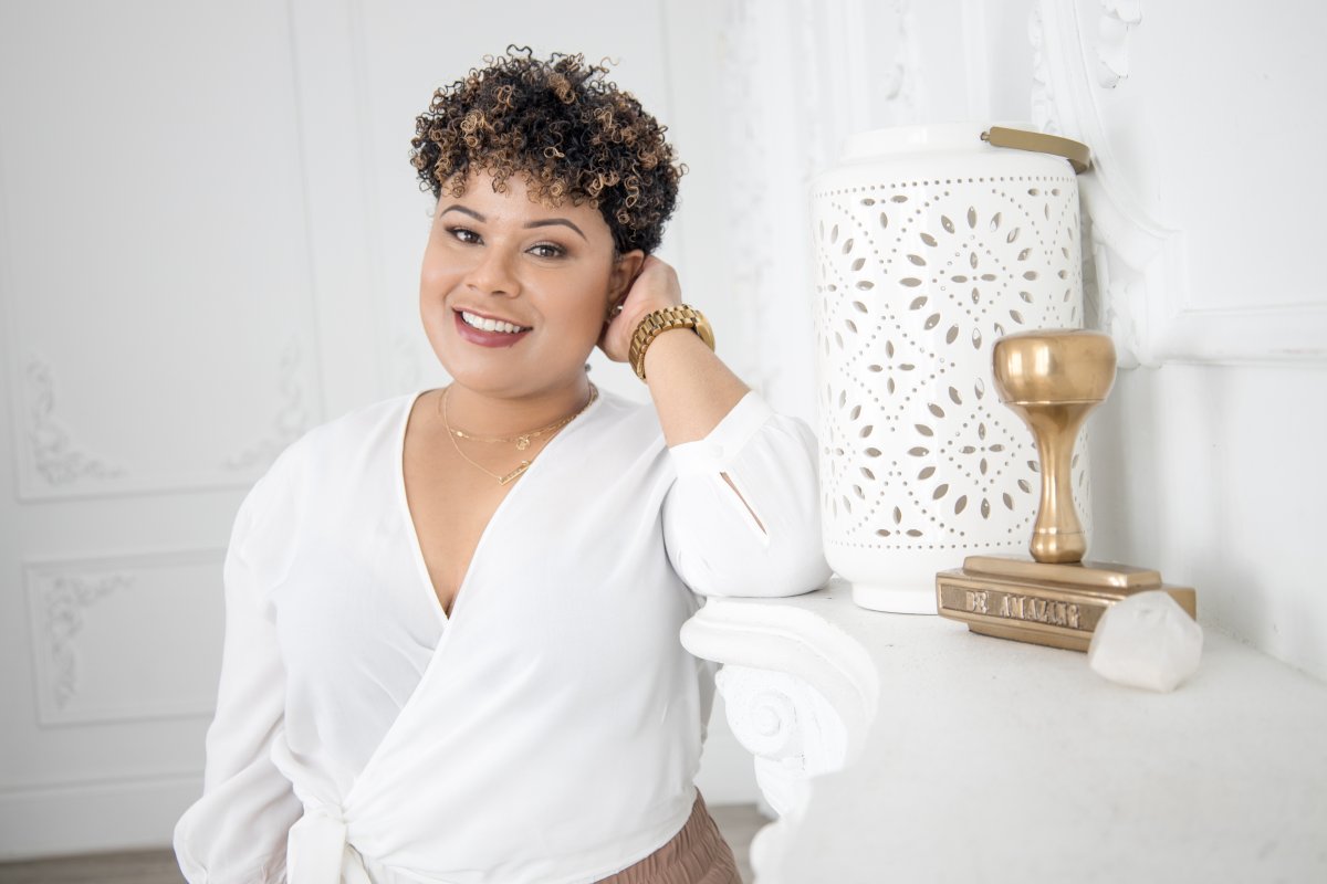 Vanessa Bowen, Creator of Mint Worthy, in a white shirt, in a white room by a white mantel