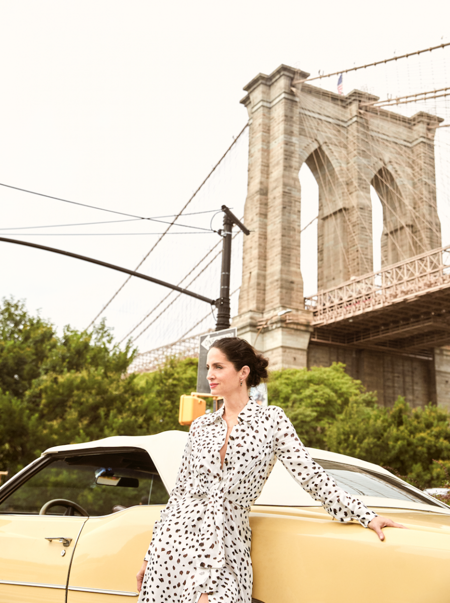 Carolina Herrera standing beside car