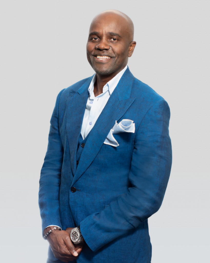 Wes Hall in a blue suit and smiling