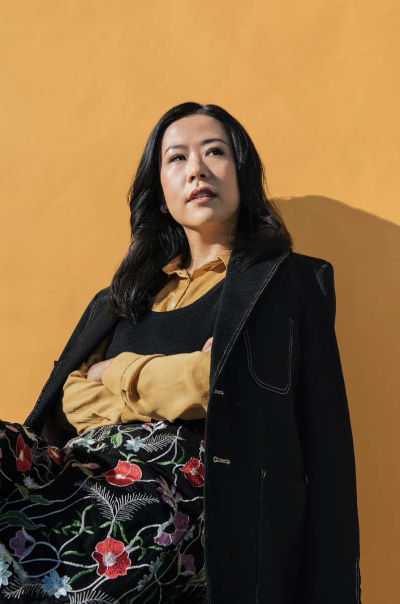 Domee Shi wearing black coat against yellow background